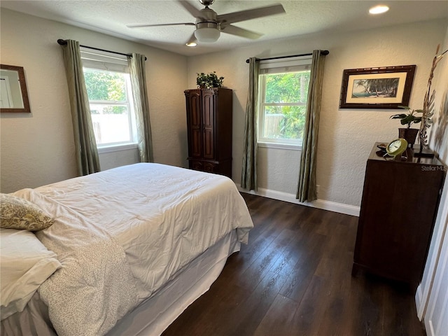 bedroom with dark hardwood / wood-style floors and ceiling fan