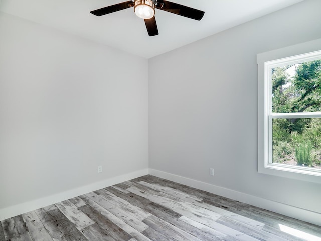 unfurnished room with ceiling fan, plenty of natural light, and light hardwood / wood-style flooring