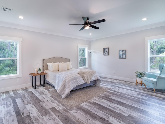 bedroom featuring light wood-type flooring, ceiling fan, and ornamental molding