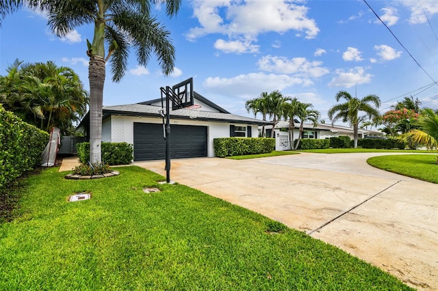 ranch-style home featuring a garage and a front lawn