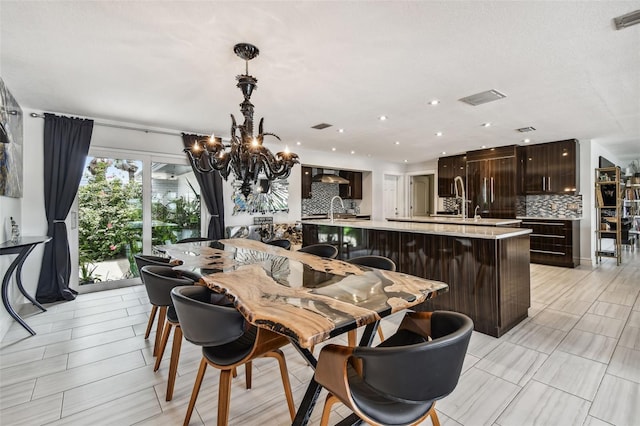 dining space with an inviting chandelier and sink