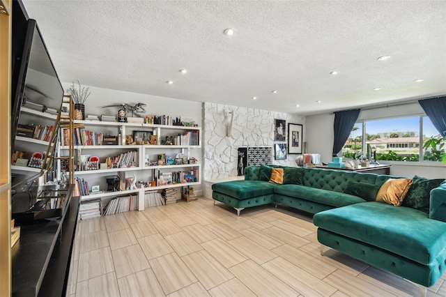 living room featuring a fireplace and a textured ceiling