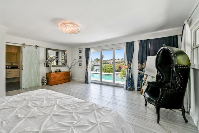 bedroom featuring a barn door and access to outside