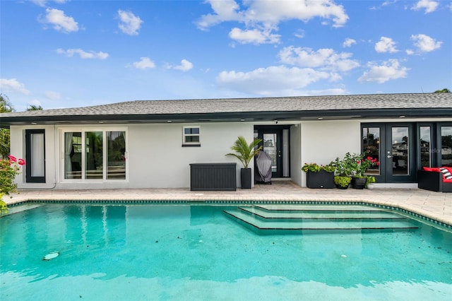 view of pool featuring a patio and french doors