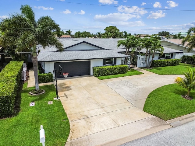 ranch-style house featuring a garage and a front lawn