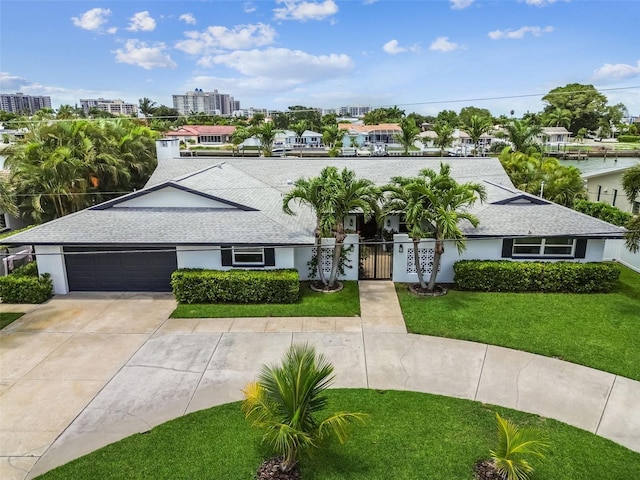 view of front of property featuring a garage and a front yard