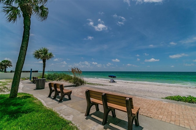 view of home's community featuring a beach view and a water view