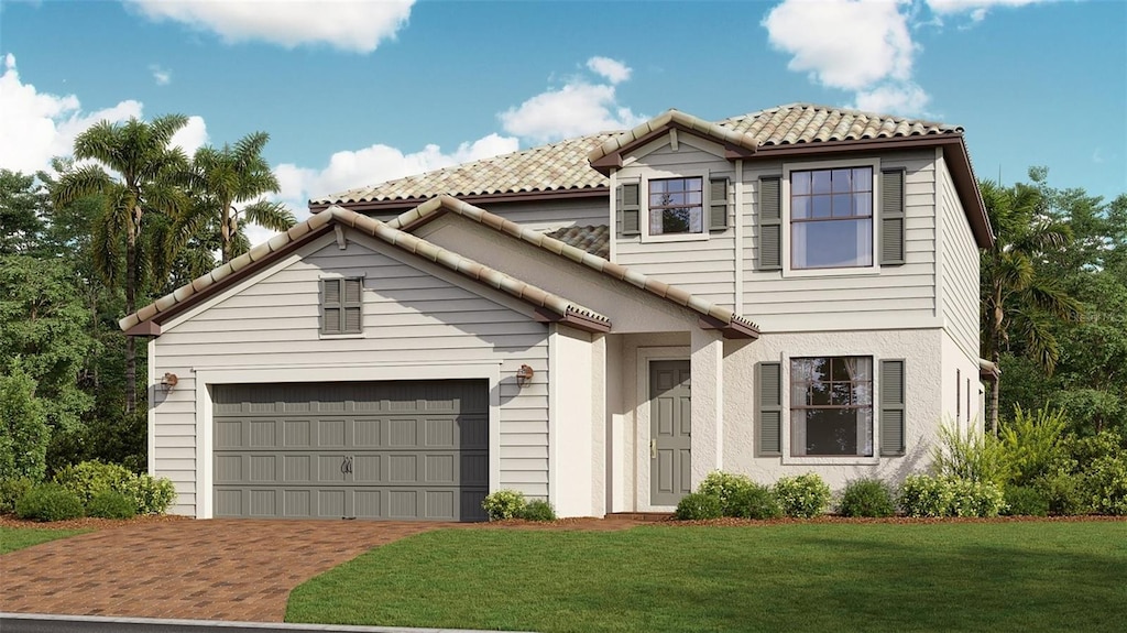 view of front of house featuring a garage and a front lawn