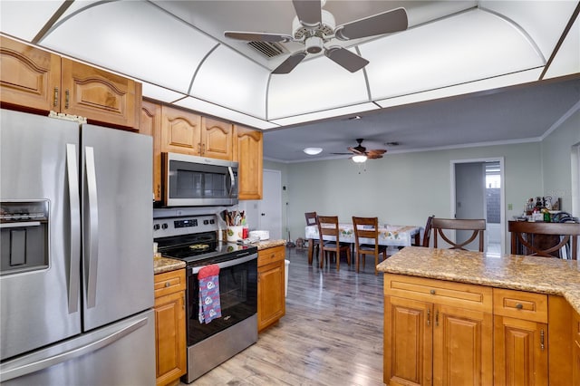 kitchen with ceiling fan, ornamental molding, light stone countertops, and appliances with stainless steel finishes