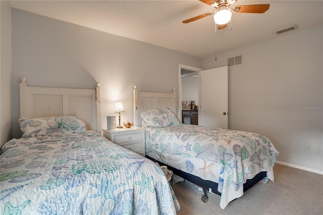 bedroom featuring ceiling fan, carpet, and a textured ceiling