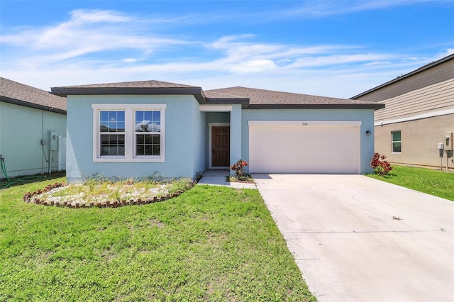 view of front of house featuring a garage and a front lawn