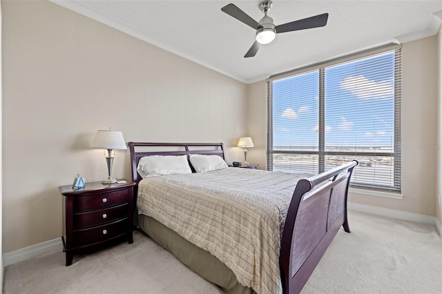 bedroom with light colored carpet, ceiling fan, and crown molding