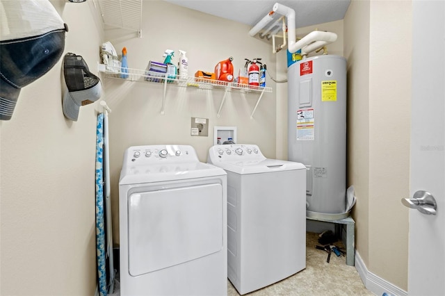 washroom with washer and dryer, electric water heater, and light carpet