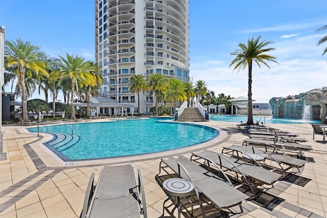 view of pool with a patio area and pool water feature