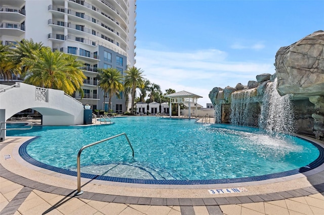 view of swimming pool featuring pool water feature