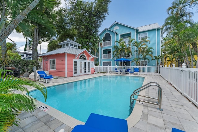 view of pool featuring a patio area and an outdoor structure