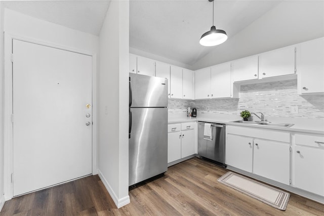 kitchen featuring pendant lighting, stainless steel appliances, white cabinetry, and sink