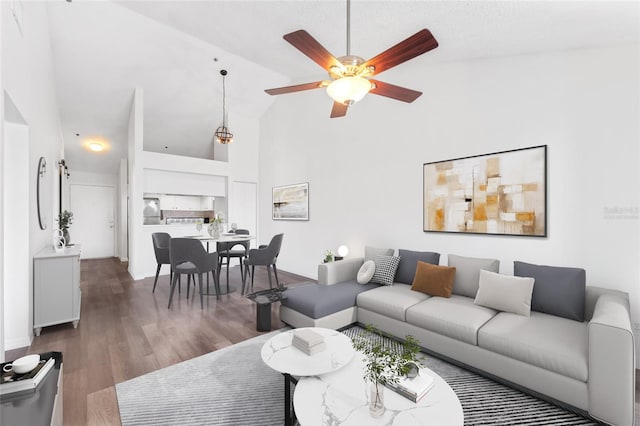 living room featuring ceiling fan, dark hardwood / wood-style flooring, and high vaulted ceiling