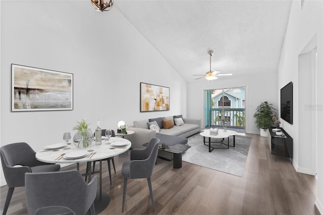 living room featuring hardwood / wood-style flooring, ceiling fan, a textured ceiling, and high vaulted ceiling