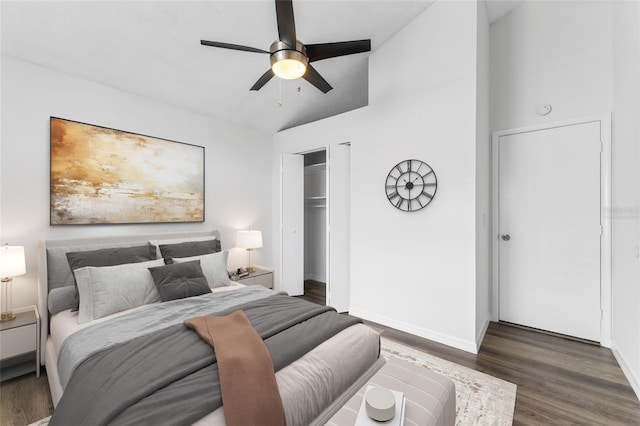 bedroom with a closet, ceiling fan, dark hardwood / wood-style flooring, and lofted ceiling