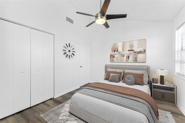 bedroom with multiple windows, dark hardwood / wood-style flooring, vaulted ceiling, and ceiling fan