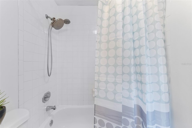 bathroom with shower / bath combo with shower curtain and toilet