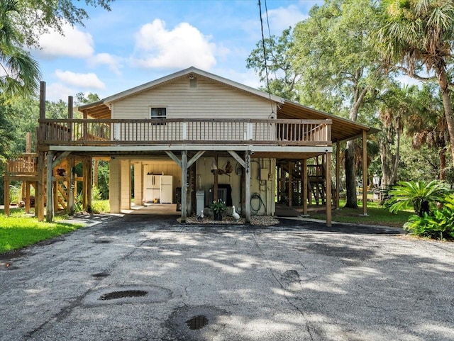 view of front facade with a carport and a deck