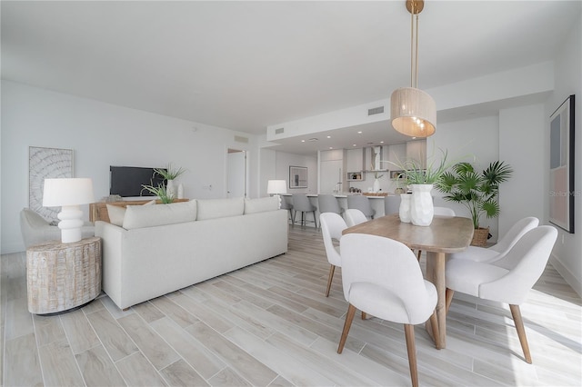 dining space with light hardwood / wood-style floors