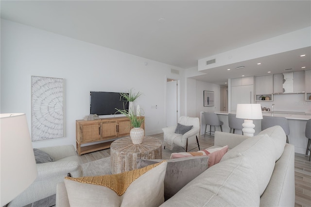 living room with light hardwood / wood-style flooring