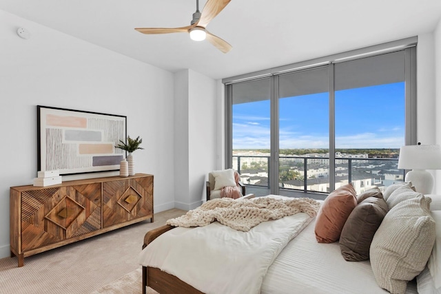 bedroom with ceiling fan, carpet, and floor to ceiling windows