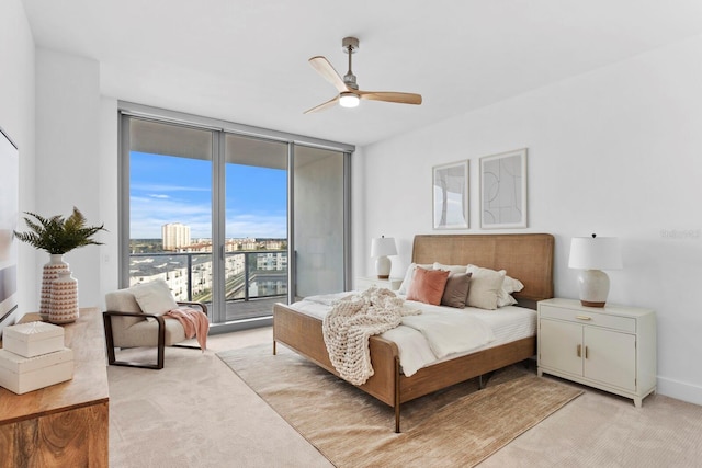 carpeted bedroom featuring ceiling fan, access to outside, and floor to ceiling windows