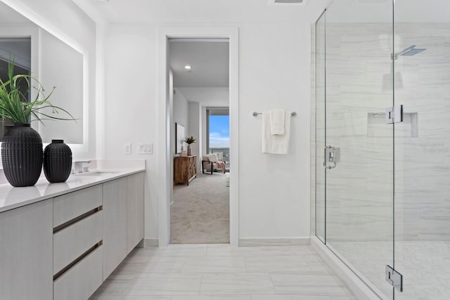 bathroom with an enclosed shower and vanity