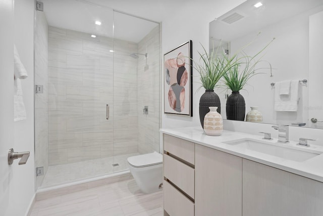 bathroom with a shower with door, toilet, and vanity