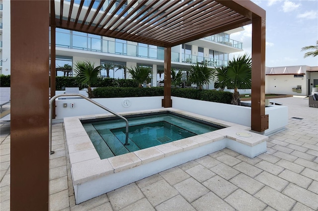 view of swimming pool featuring a hot tub and a pergola