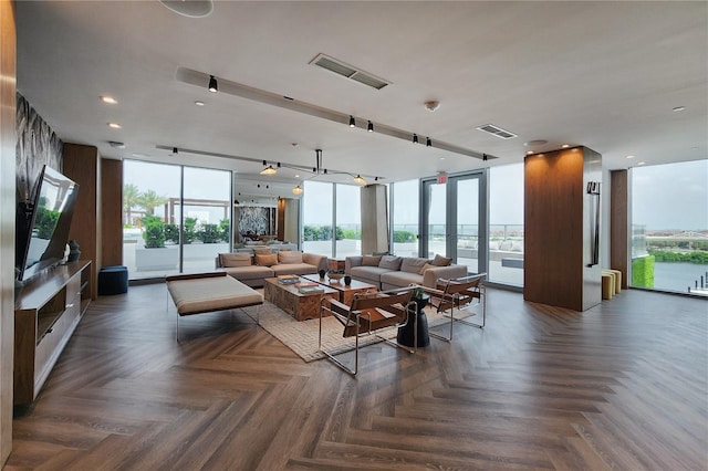 living room with a wall of windows and dark parquet flooring