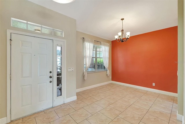 entrance foyer with light tile patterned flooring and a notable chandelier