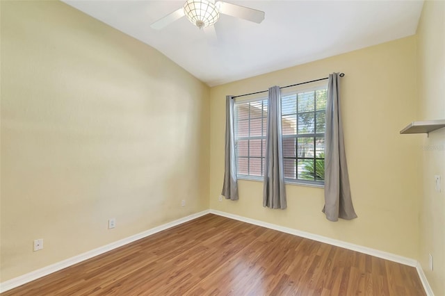 spare room featuring ceiling fan, wood-type flooring, and lofted ceiling