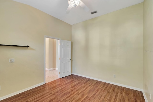 unfurnished room with ceiling fan and light hardwood / wood-style floors