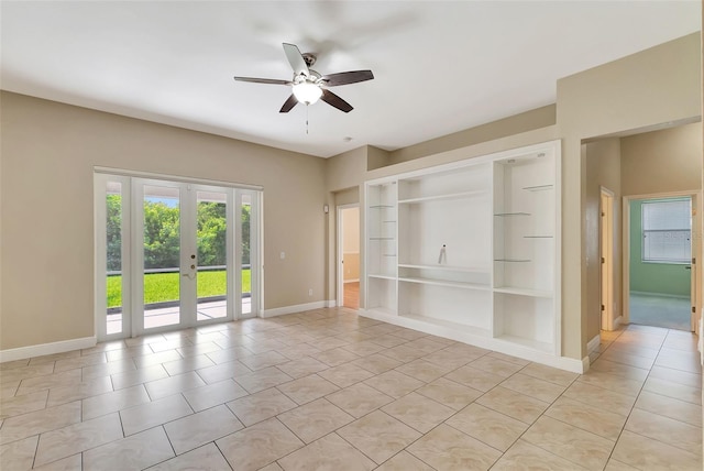 tiled empty room with ceiling fan, built in features, and french doors