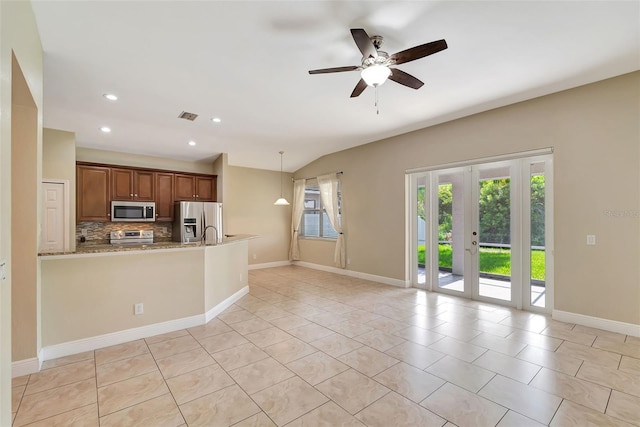 kitchen with decorative backsplash, ceiling fan, light stone countertops, decorative light fixtures, and stainless steel appliances