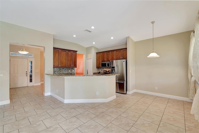 kitchen featuring decorative backsplash, light tile patterned floors, kitchen peninsula, and appliances with stainless steel finishes