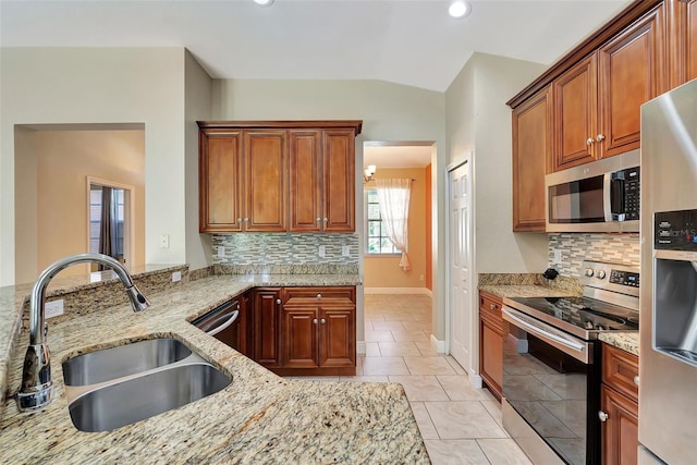 kitchen featuring light stone countertops, stainless steel appliances, light tile patterned flooring, and sink