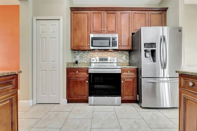 kitchen with decorative backsplash, light stone countertops, and appliances with stainless steel finishes