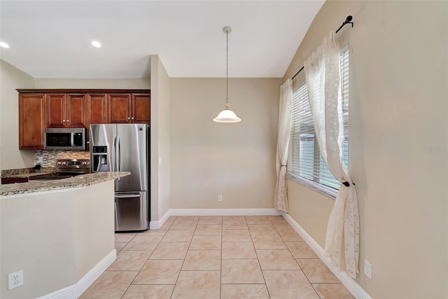 kitchen featuring light stone countertops, tasteful backsplash, stainless steel appliances, light tile patterned floors, and decorative light fixtures