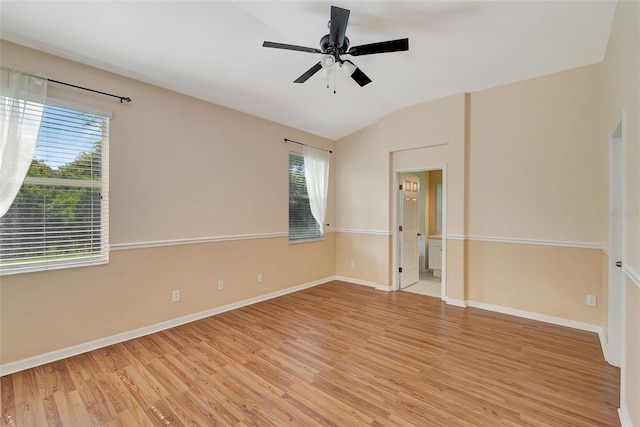 empty room with light wood-type flooring, vaulted ceiling, and ceiling fan