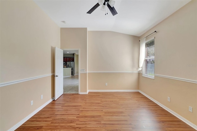 empty room featuring light hardwood / wood-style flooring, ceiling fan, and lofted ceiling