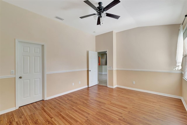 unfurnished room with light hardwood / wood-style flooring, vaulted ceiling, and ceiling fan