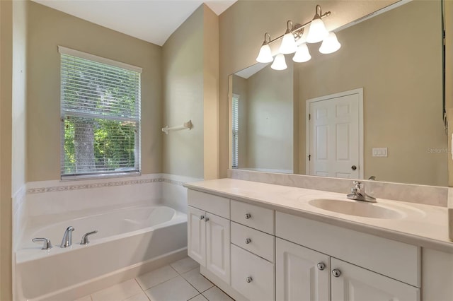 bathroom with tile patterned floors, vanity, and a bath