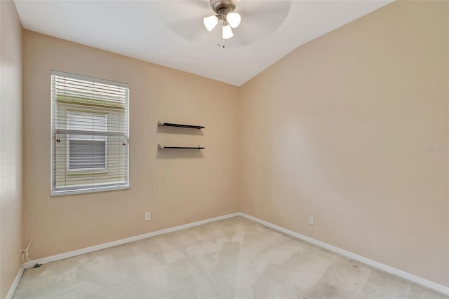 carpeted spare room featuring ceiling fan