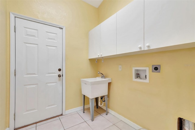 clothes washing area featuring hookup for an electric dryer, light tile patterned flooring, cabinets, and washer hookup